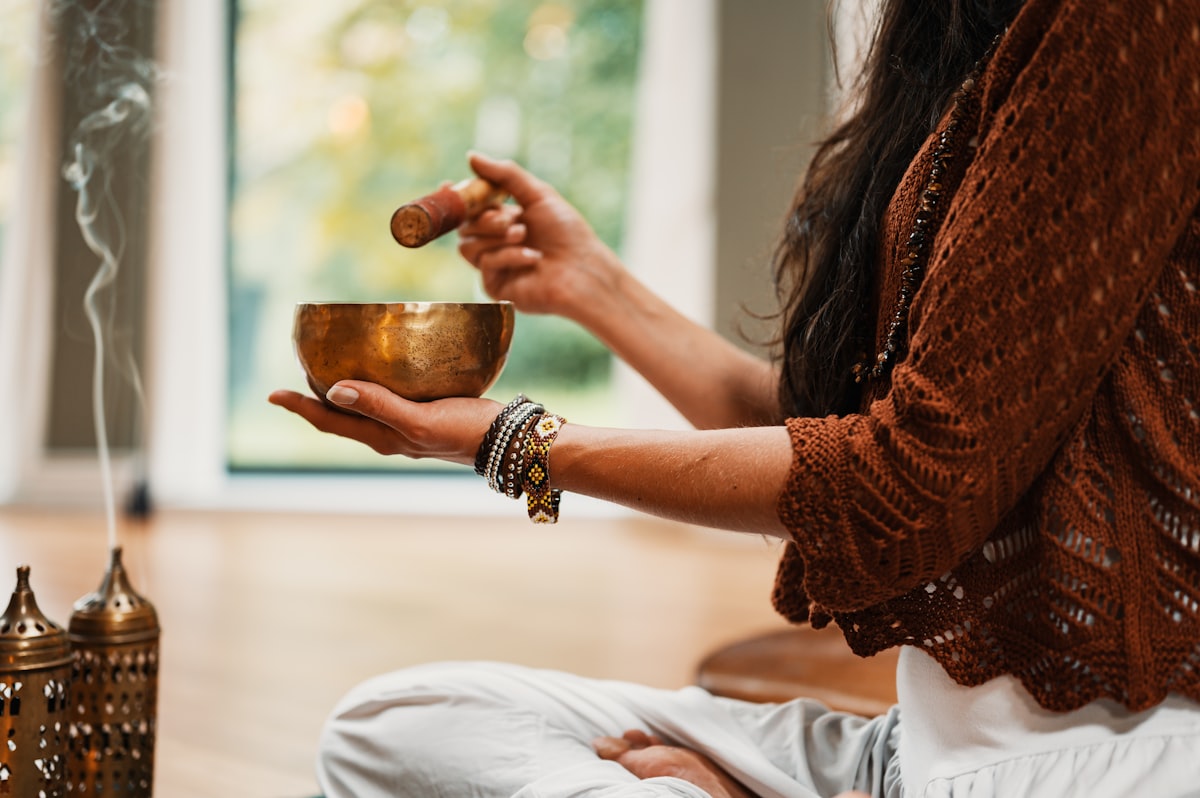 Hands holding a singing bowl during a quiet ritual